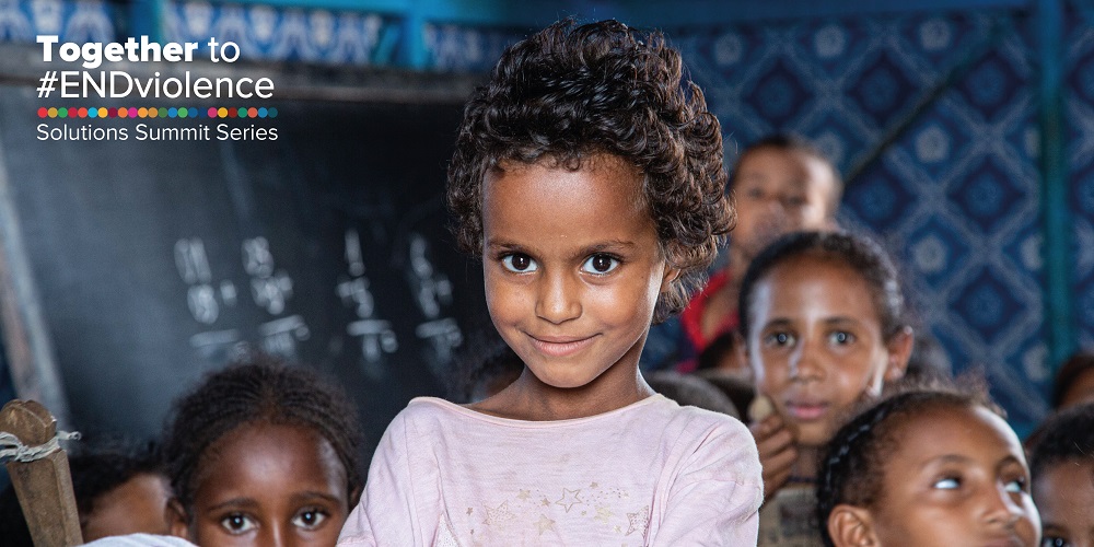 A child with the Solutions Summit logo.